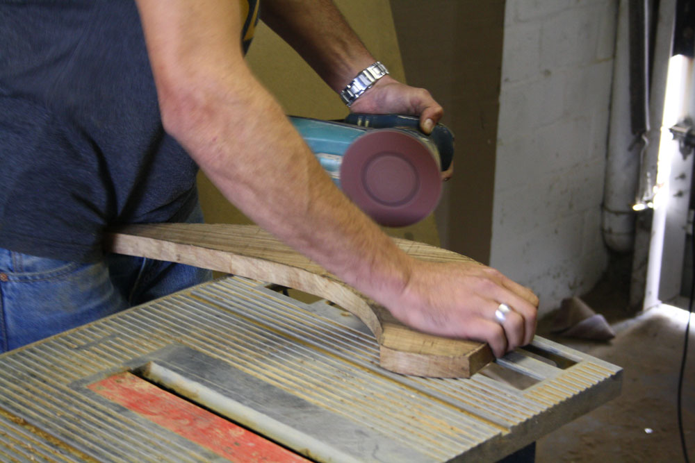 Using a power sander, smooth out the curve.